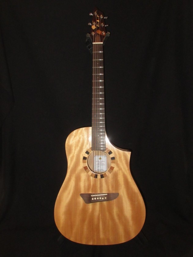 Solid Okoume top, back, and sides florentine cutaway dreadnought. 